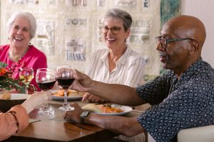 Debunking active senior living myths holly creek residents enjoying dinner