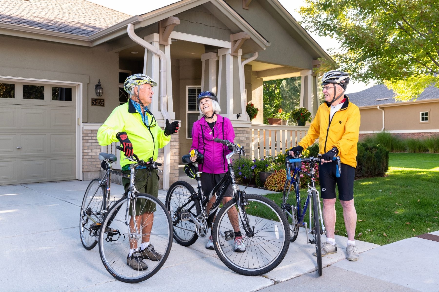 cyclist conversing outside home landscape