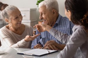 Moving and downsizing couple meeting with executive director