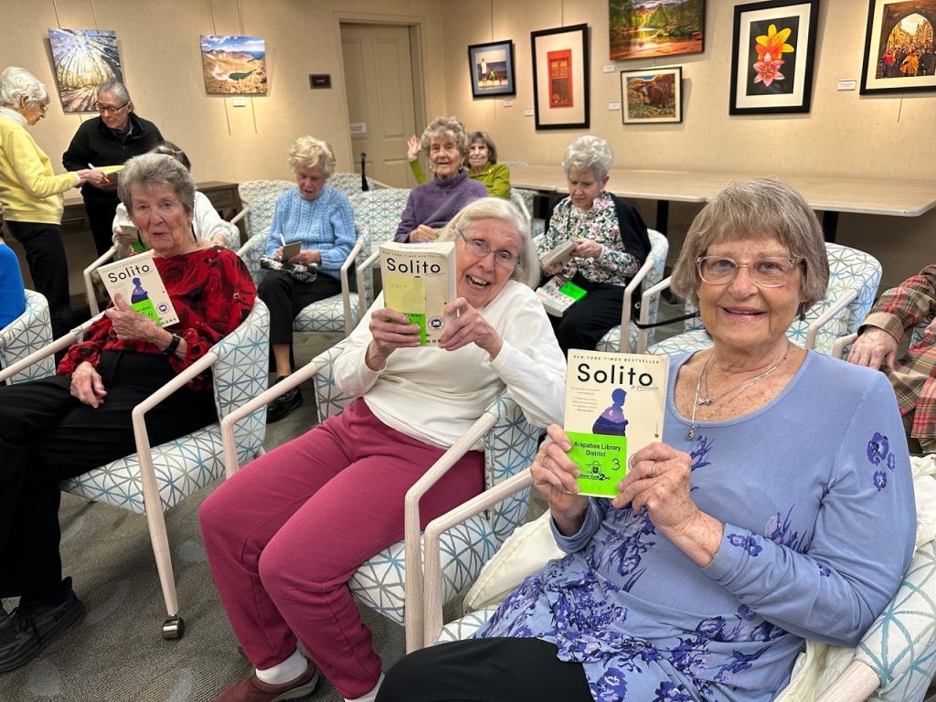 Holly Creek book club members hold up their March read.