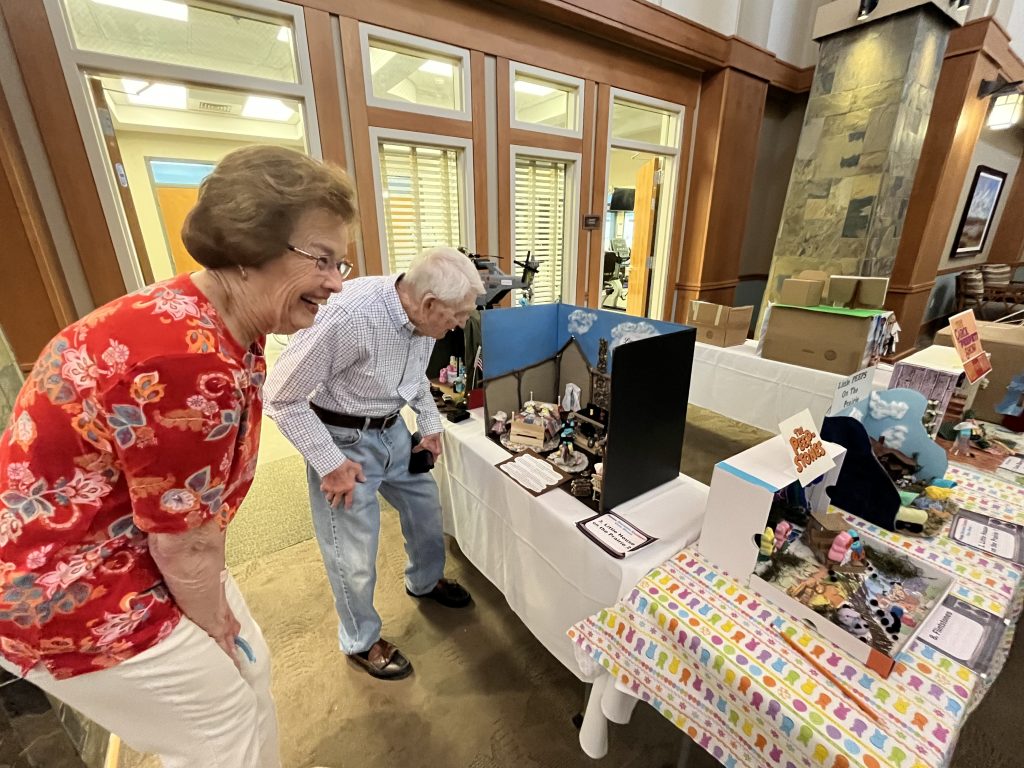 Betty Detweiler admiring her team's winning peeps diorama with a neighbor